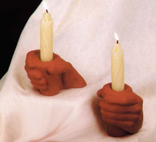 the candles are held in the fists of these hands