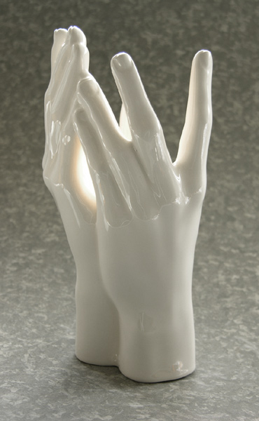 two hands with a bulb between them