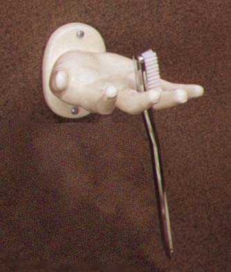 the toothbrush is held between the fingers